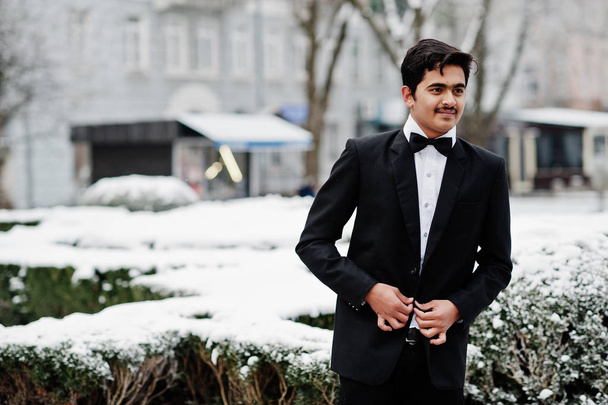 Young indian man on suit and bow tie posed outdoor in winter day. - Photo, image
