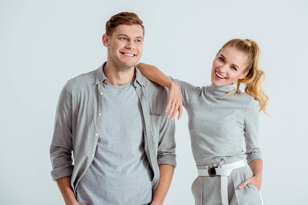 beautiful smiling couple looking at camera and posing isolated on grey - Fotoğraf, Görsel