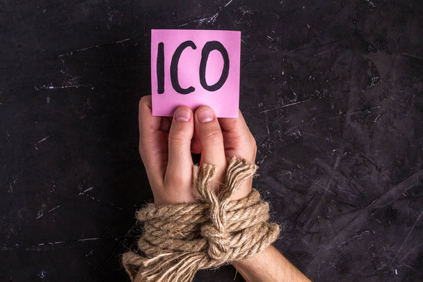 Prohibition and illegal launching ICO. Initial coins offering outlawed, Male hands in rope - Photo, Image
