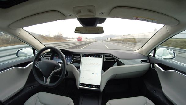 TESLA AUTONOMOUS CAR, MARCH 2017: Absolutely autonomous self-driving autopilot Tesla Model S driverless car with next gen ultrasonic sensors, cameras and radars driving along the turnpike highway - Foto, immagini