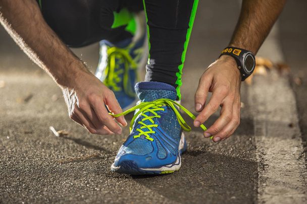 Χαμηλή γωνία προβολής του ανθρώπου προετοιμασία παπούτσι για τρέξιμο - Φωτογραφία, εικόνα