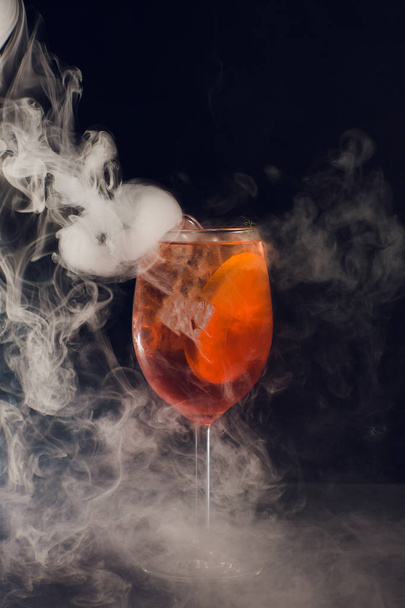 Beautiful cocktail isolated with dry ice smoke. - Фото, изображение