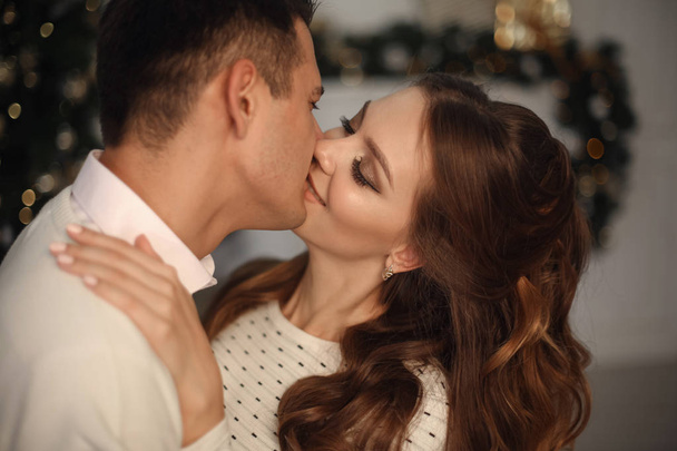 Close-up of young romantic couple is kissing at home. Happy smiling woman emrace her handsome man. - Fotó, kép