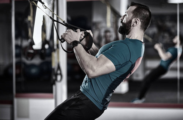 Fitness trainer working with trx straps for crossfit workout - Zdjęcie, obraz