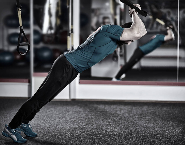 Fitness trainer working with trx straps for crossfit workout - Zdjęcie, obraz