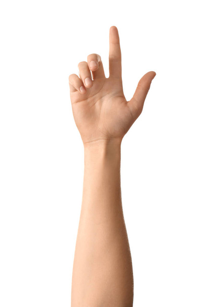 Mão feminina apontando para algo no fundo branco
 - Foto, Imagem