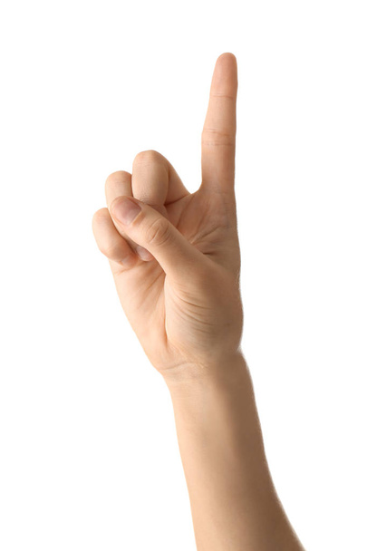 Mano femenina con dedo índice elevado sobre fondo blanco
 - Foto, imagen
