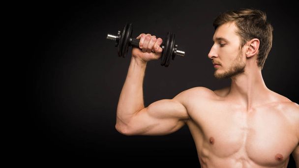Close up portrait of a man with dumbell - Foto, Imagen