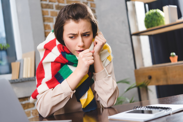 sick young businesswoman in scarf coughing at workplace - Photo, Image