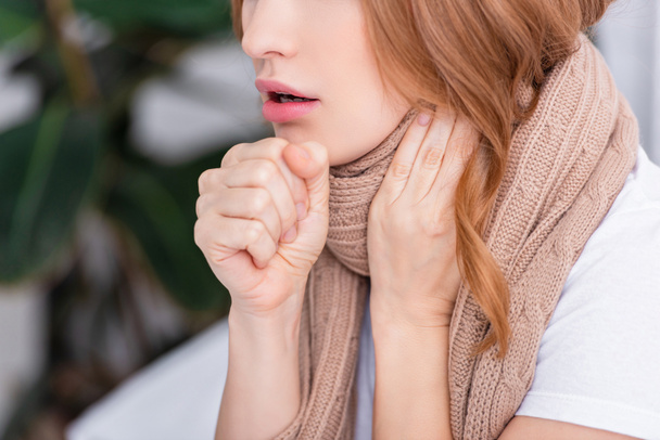 cropped image of sick woman coughing and touching neck at home - Photo, Image