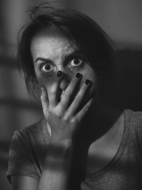 Scared woman with dirty face in shadows. Black and white. - Фото, изображение
