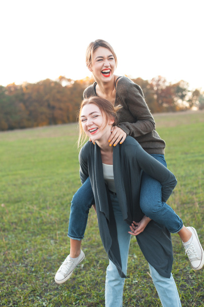Two young women are having fun outdoors. Best friends - Fotoğraf, Görsel