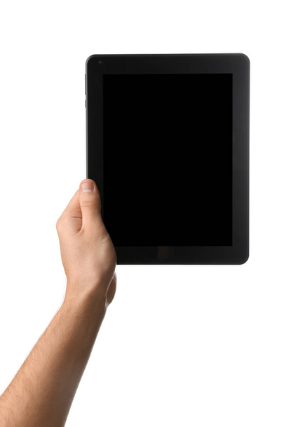 Young man holding tablet PC on white background - Foto, imagen
