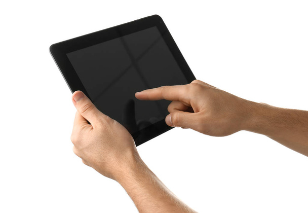 Young man using tablet PC on white background - Foto, imagen