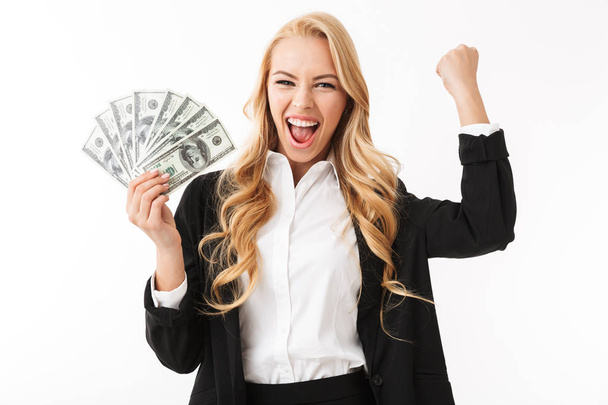 Portrait of businesslike woman wearing office clothing holding fan of money isolated over white background - Photo, Image