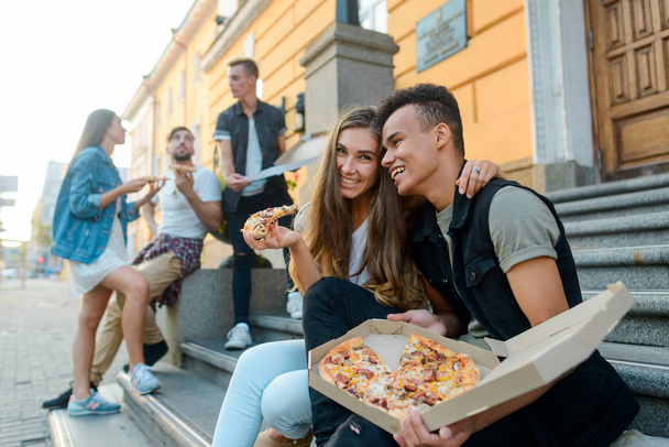 Cheerful guys eating a pizza - Фото, зображення