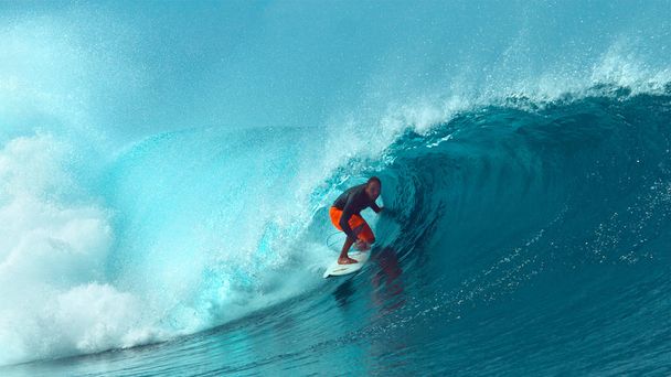 Közelről: A Glassy óceán víz loccsan felső a tapasztalt szörfös lovagolt egy nagy cső hullám. Lenyűgöző lövés, extrém lovas kihívást magát lovagolni a belsejében egy nagy üreges hordó hullám a Tahiti. - Fotó, kép