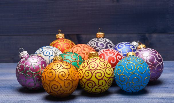 Balls with glitter and shimmering decorative ornaments. Christmas ornaments decorations on vintage wooden background. Christmas decorations concept. Pick colorful decorations. Modern christmas decor - Фото, зображення