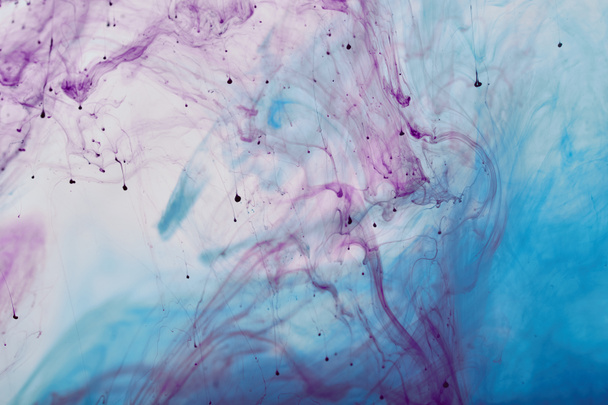 smoky background with purple and blue mixing swirls of paint - Foto, Imagen