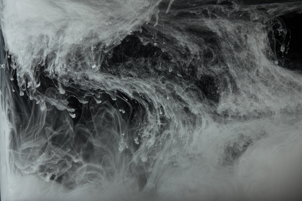 abstract flowing swirls of grey paint in water - Fotoğraf, Görsel