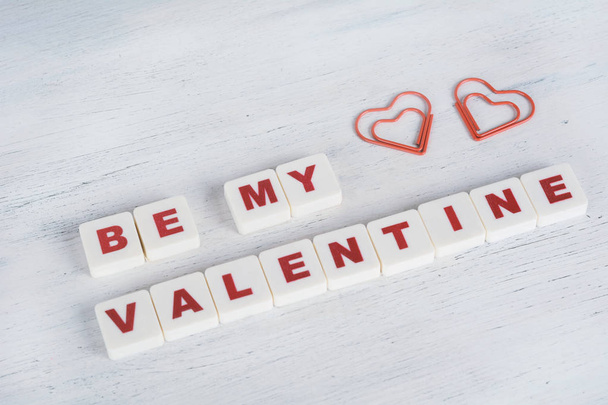 Phrase "be my valentine" made from letter cubes with hearts shape on white wooden background. Valentine's Day concepy. - Foto, Imagem