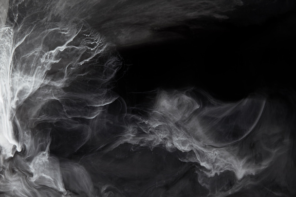 remolinos abstractos de pintura gris sobre fondo negro
 - Foto, Imagen