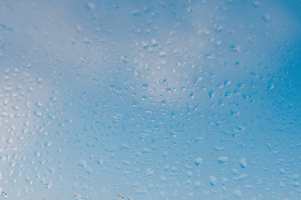 Strong humidity in wintertime. Water drops from home condensation on a window. Misted glass background - Photo, Image