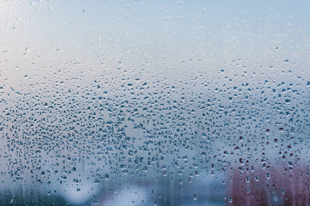 Misted glass background. Strong humidity in wintertime. Water drops from home condensation on a window - Photo, Image