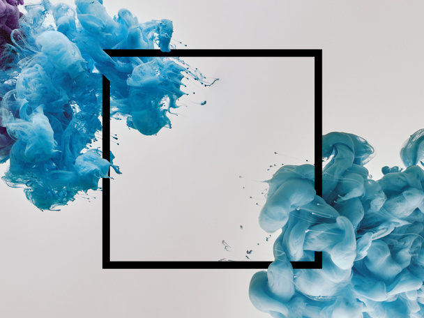 blue splashes of paint with square frame on white background - Photo, Image