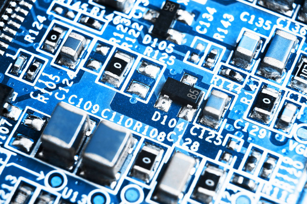 Macro shot of a Circuitboard with resistors microchips and electronic components. Computer hardware technology. Integrated communication processor. Information engineering. Semiconductor. PCB. Closeup - 写真・画像