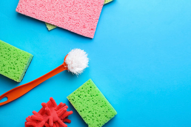 Flat lay composition with cleaning supplies on color background - Foto, immagini