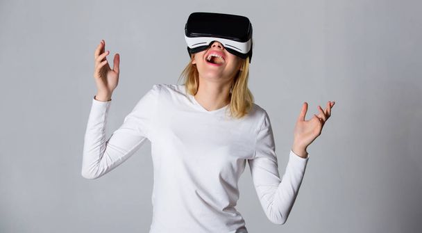 Woman with virtual reality headset. Portrait of an amazed girl using a virtual reality headset isolated on grey background. Funny young woman with VR. Woman VR. - Φωτογραφία, εικόνα