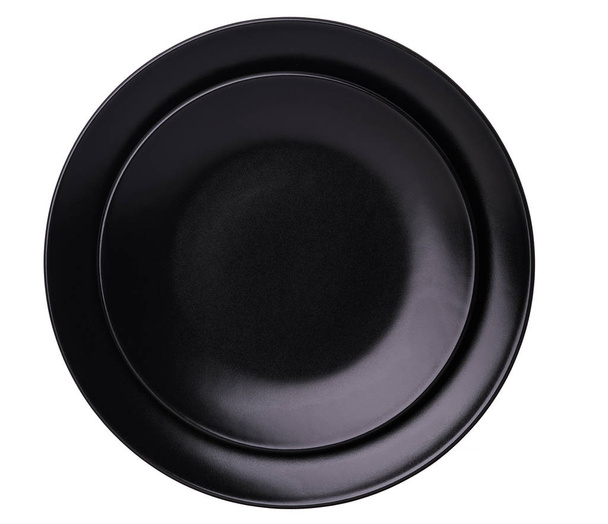 Üres kerámia fekete tányér elszigetelt fehér background, a vágógörbe, felülnézet - Fotó, kép