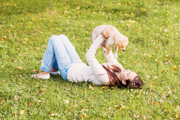 Girl with her dog resting outdoors - Foto, Imagen
