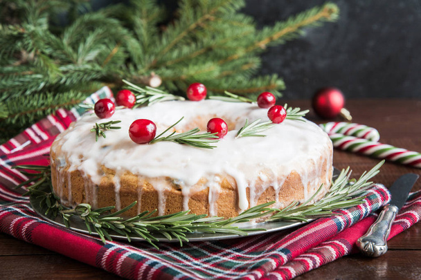 Traditional homemade Christmas cake decorated cranberry berry and rosemary on plate. - Fotografie, Obrázek