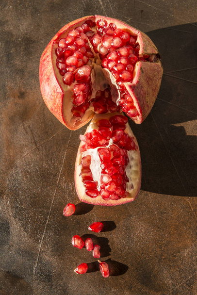 Healthy food concept. Still life with pomegranates on wooden table. - Fotó, kép