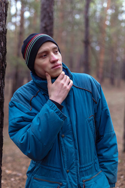 A rural guy posing in a pine forest in the autumn time - Valokuva, kuva