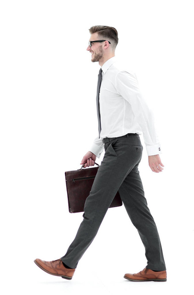 side view.a confident businessman with a leather briefcase goes forward - Foto, afbeelding