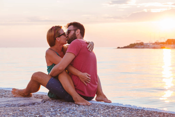 Young couple in love enjoying their honeymoon at the seaside - Fotó, kép