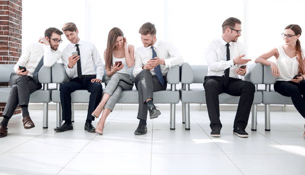 group of young employees communicate sitting in the office lobby - Photo, Image