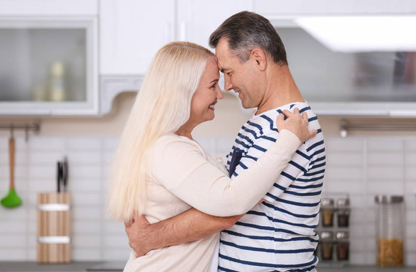 Happy mature couple dancing in kitchen - Photo, Image