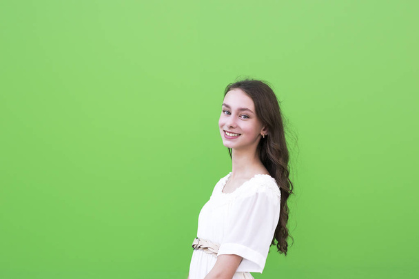Charming woman on green wall - Foto, Bild