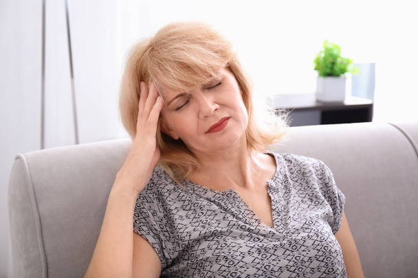 Mature woman suffering from headache at home - Φωτογραφία, εικόνα