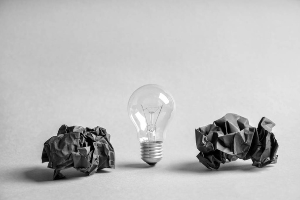 Light bulb with crumpled paper on white background - Photo, Image