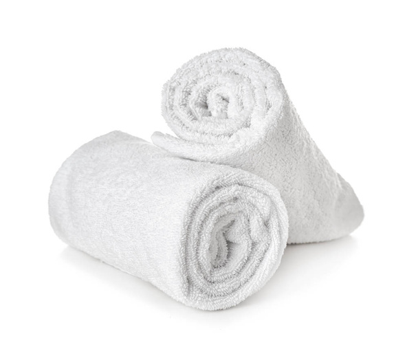 Rolled fluffy towels on shelf in bathroom Stock Photo by FabrikaPhoto