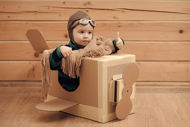 cardboard plane, childhood, little boy pilot. - Foto, imagen