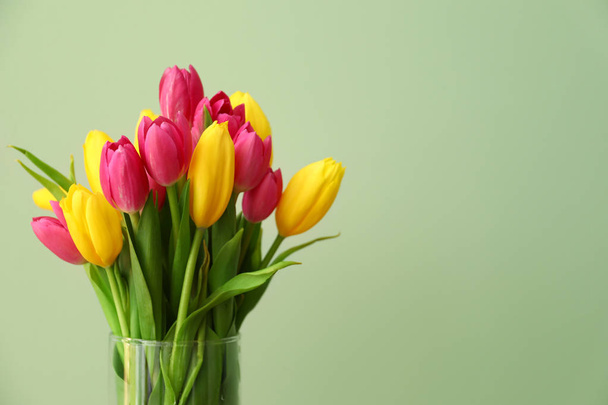 Vase with beautiful tulips on color background - Photo, Image
