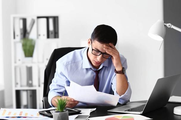 Stressed young businessman in office - Photo, Image