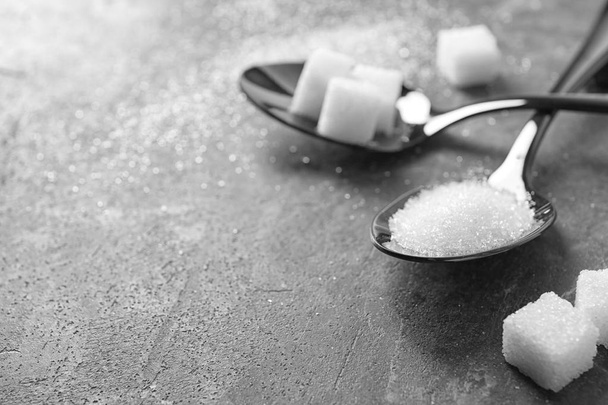 Spoons with sugar on grey table - Photo, Image