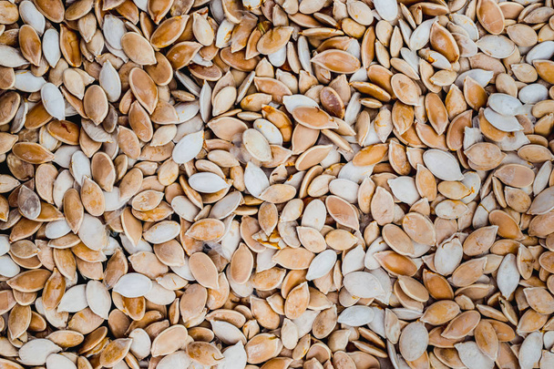 Raw pumpkin seeds background for design. - Valokuva, kuva